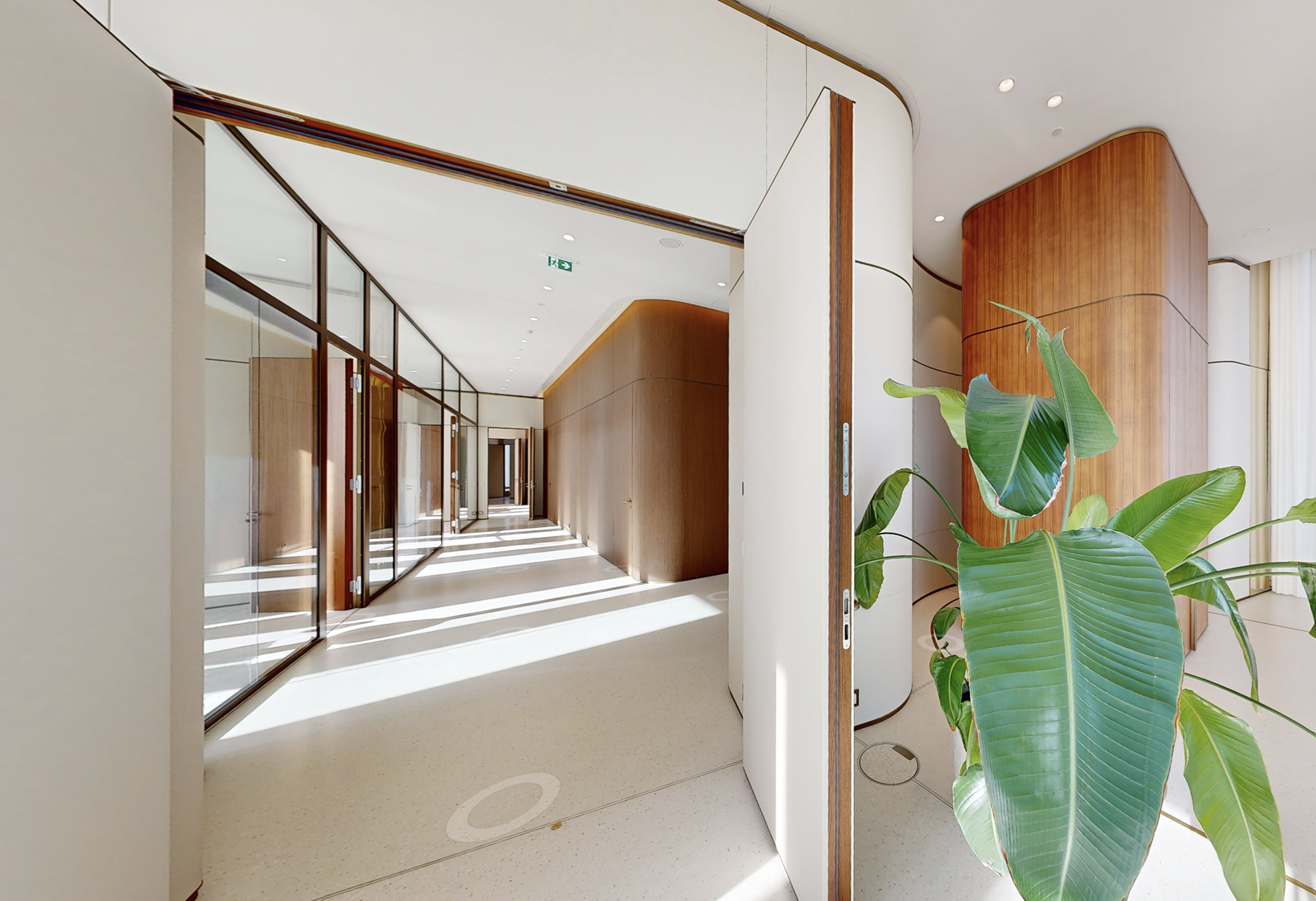 The residence corridor, walnut and light on the 33rd floor